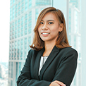 Businesswoman standing confidently in an office setting.