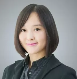 Professional portrait of a person with short hair in a suit.