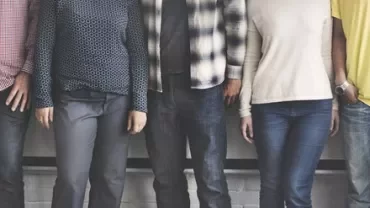 A group of people standing together, showing only their torsos.