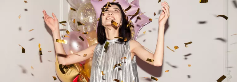 female person celebrating life, balloons, confetti
