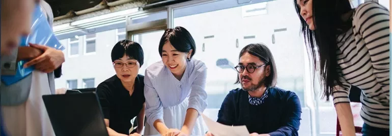 a group of co-workers working together in an office