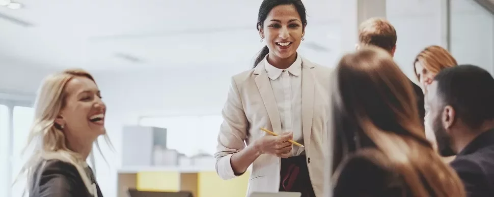 Smiling woman in a business meeting with colleagues.