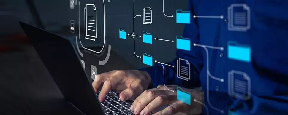 Person typing on laptop with digital folder icons overlayed.