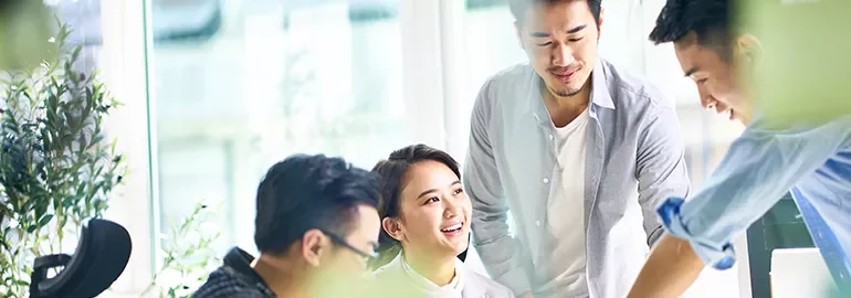 Group of people having a discussion in a bright office setting.